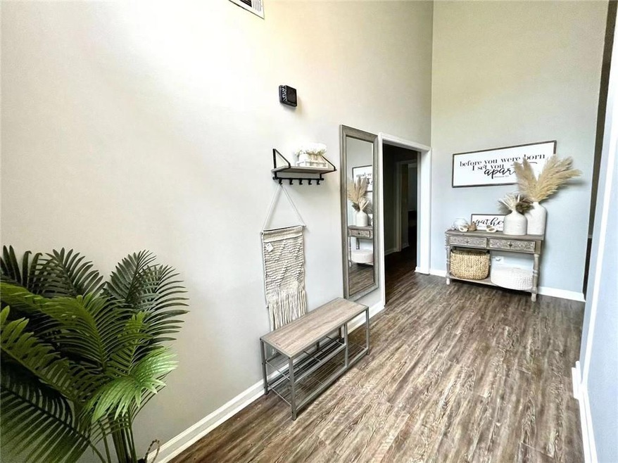 Hallway featuring a high ceiling and dark hardwood