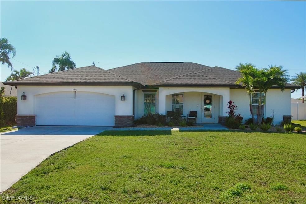 Single story home with a garage and a front yard