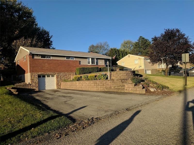 Front of home shows paved driveway, professionally