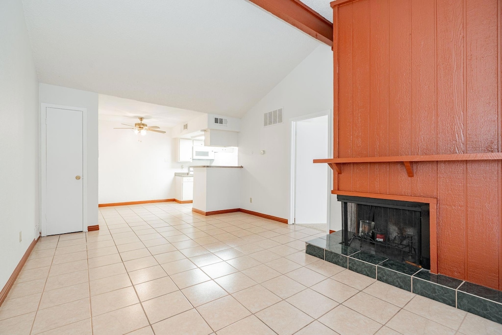 Unfurnished living room featuring ceiling fan, lig