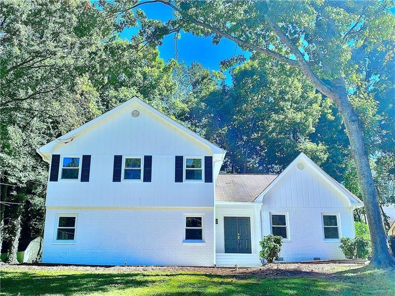 House sits in a cul de sac with a newly painted wh