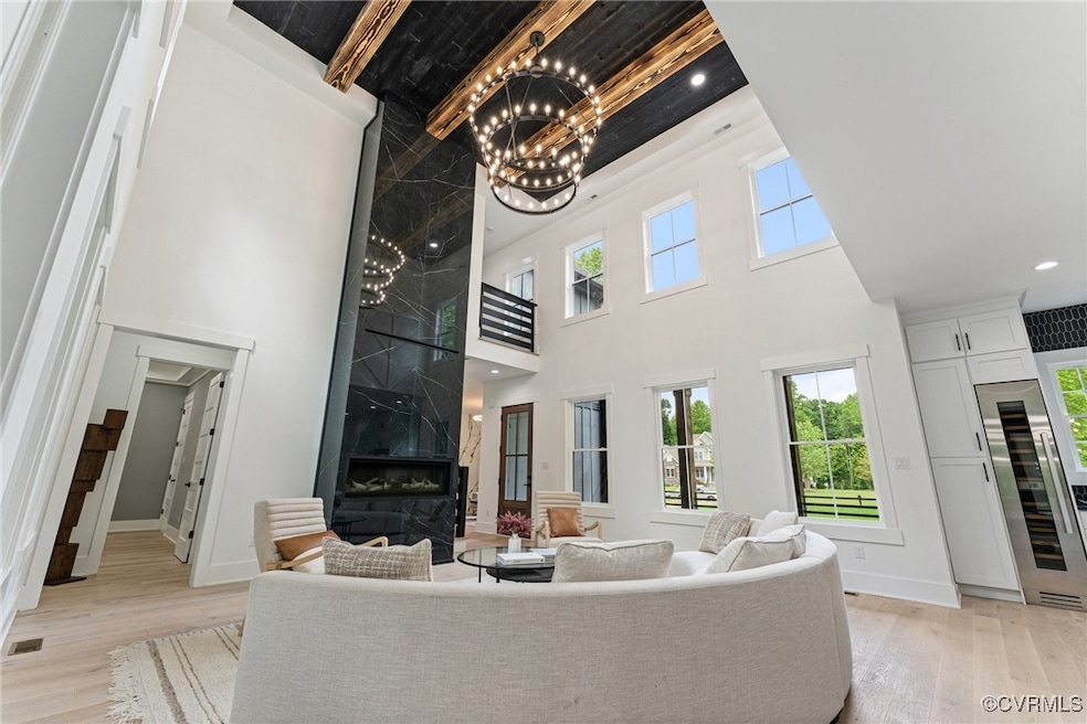 Two Story fireplace surround with exposed beams an