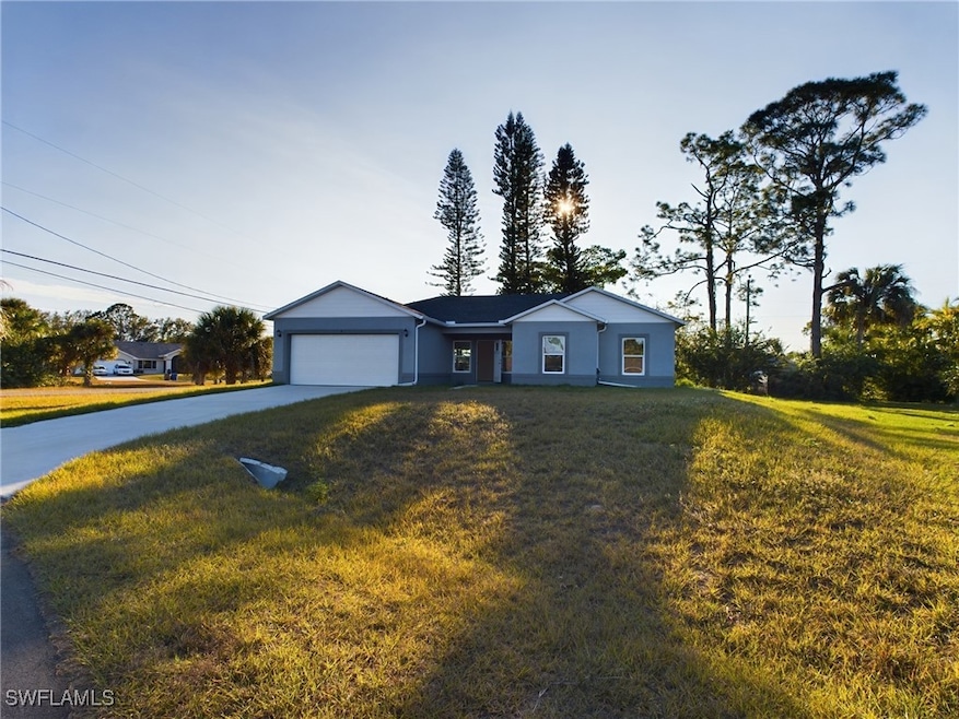 Single story home with a front lawn and a garage