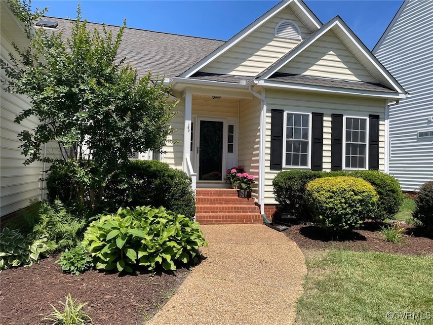 View of front of home with a shingled roof and ent