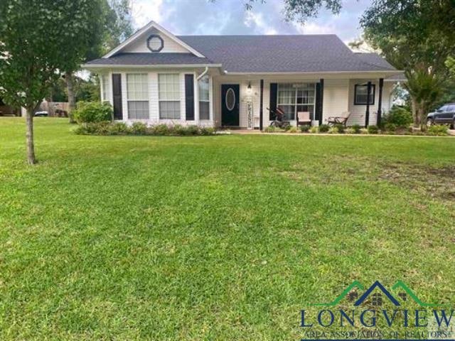 Ranch-style home with covered porch and a front ya