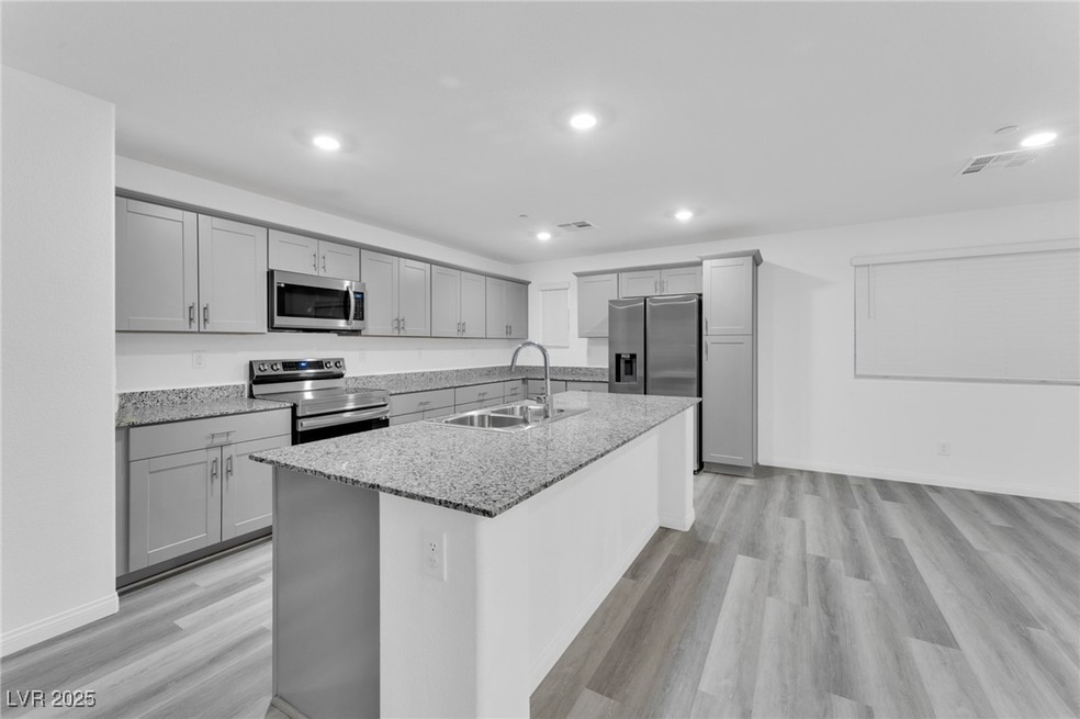 Kitchen with light stone counters, appliances with