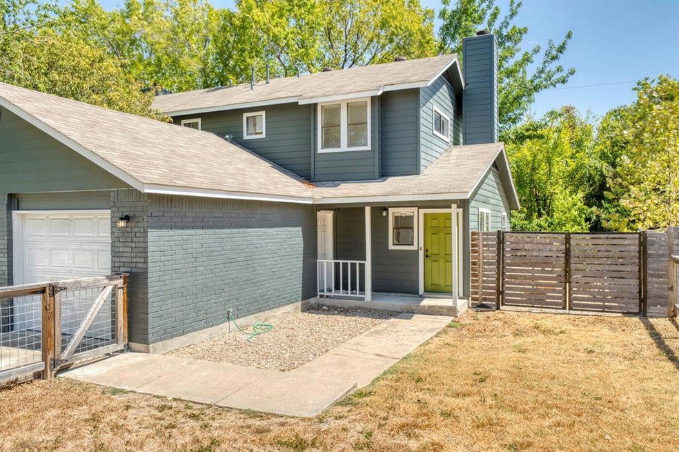 Front of the home with ffully fenced front yard.