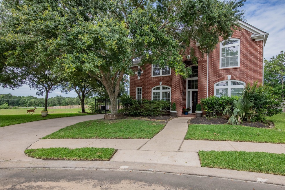 Charming brick home with lush landscaping and a we