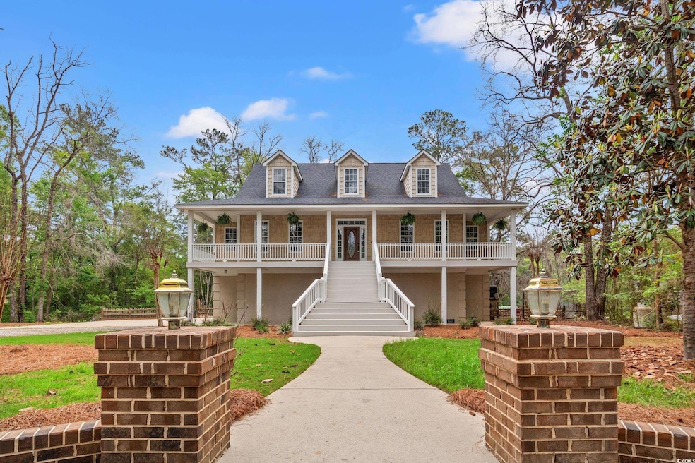 View of front of home with a porch, stairs, a fron