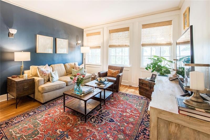 Natural light floods the living room through the o