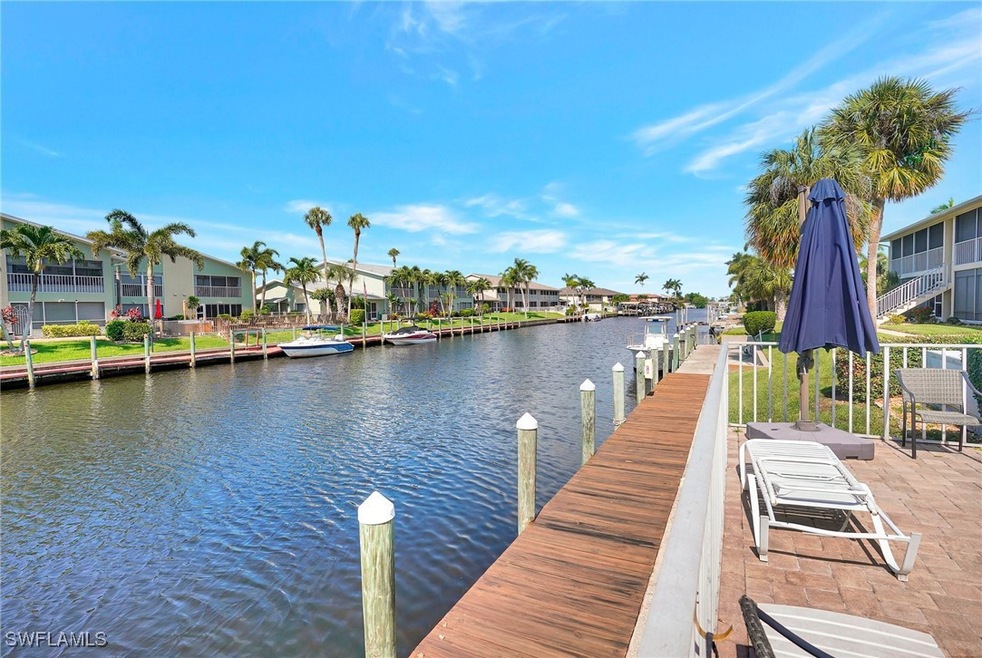 Dock with a water view and a residential view