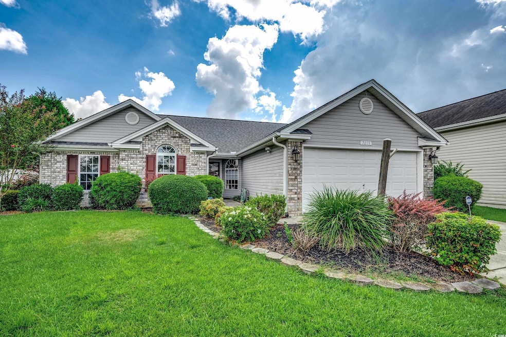 Ranch-style home with a front yard and a garage