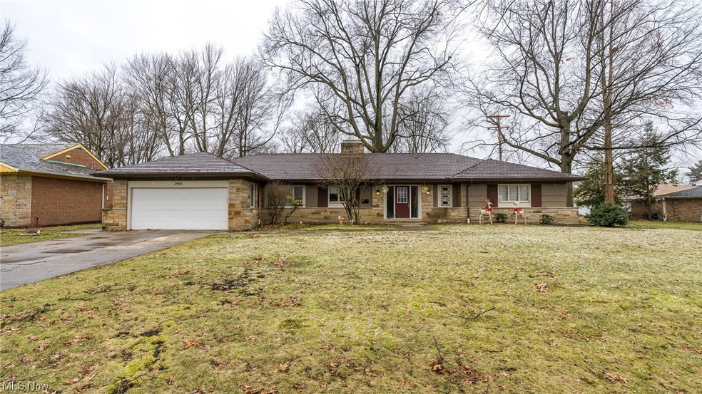 Ranch-style house featuring a garage and a front yard