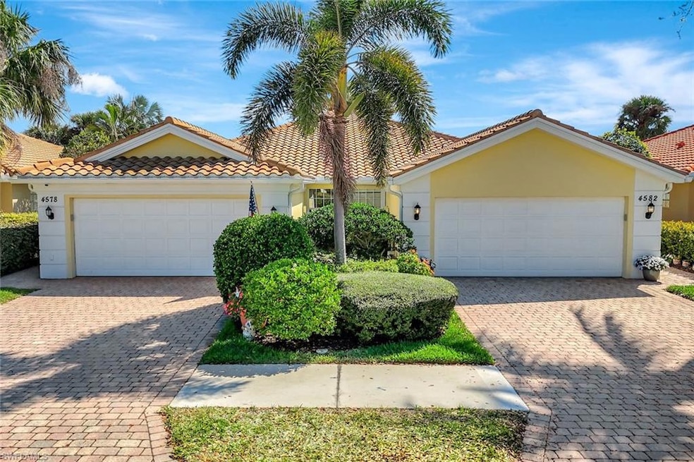 View of front of home featuring a garage, a tile r