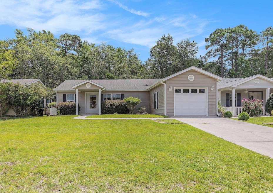 Single story home featuring a garage, concrete driveway, and a front yard