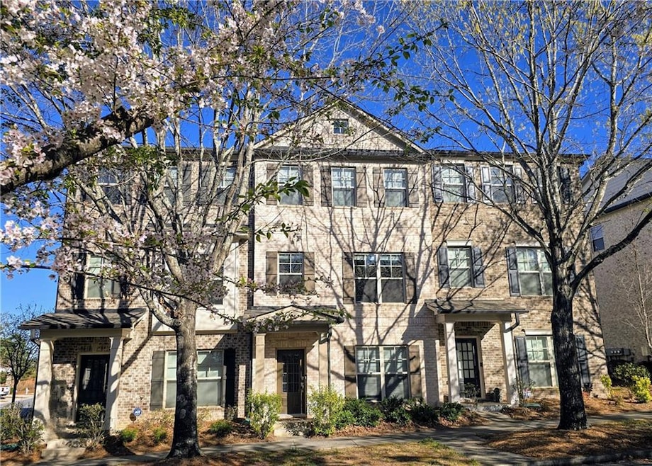 Townhome property with brick siding