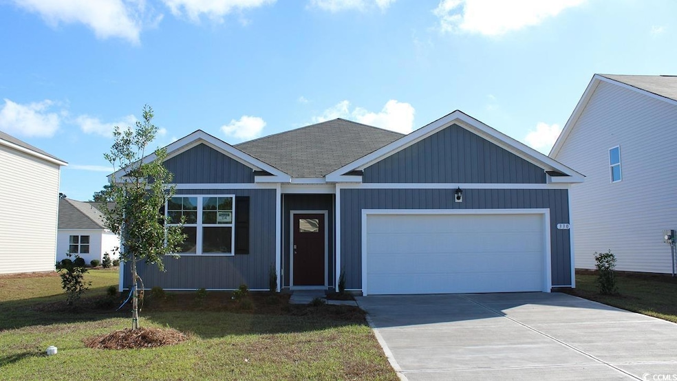Ranch-style house featuring an attached garage, concrete driveway, and a front yard