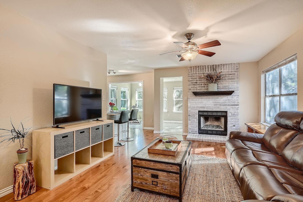 Living area featuring light wood-style floors, pl