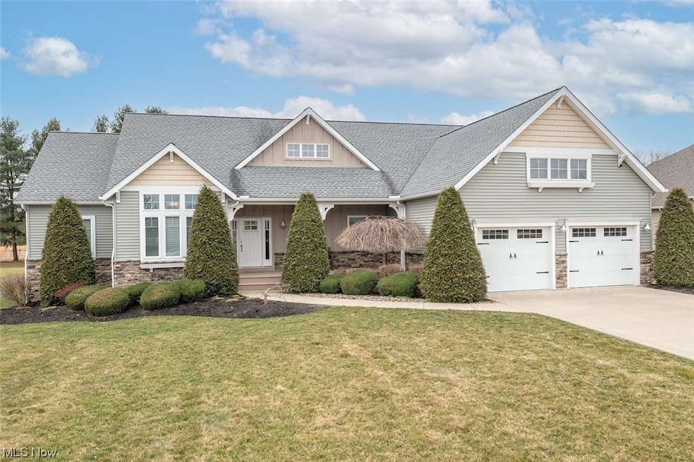 Craftsman-style house featuring a front lawn, a porch, and a garage