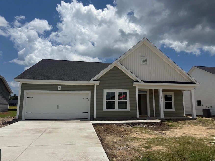 View of front facade featuring driveway, an attached garage, a porch, board and batten siding, and roof with shingles