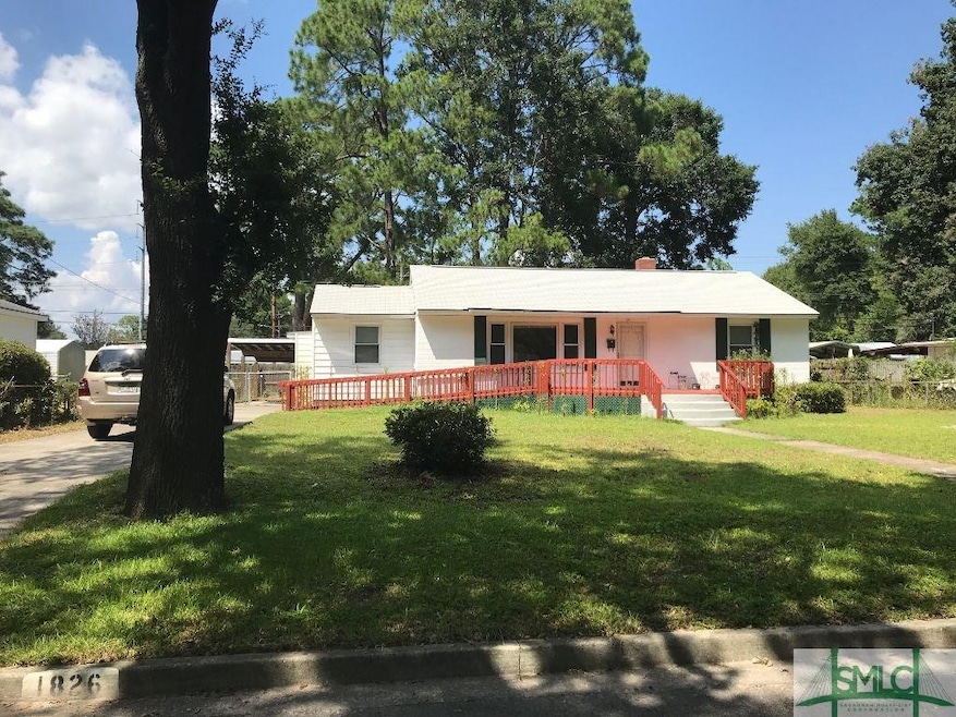 Front View.  Brick and Aluminum Siding.  Front Deck and Wheelchair Ramp