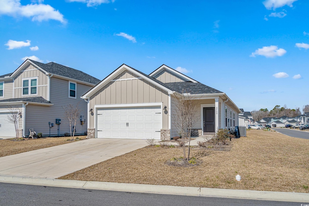 View of front of house with concrete driveway, a g