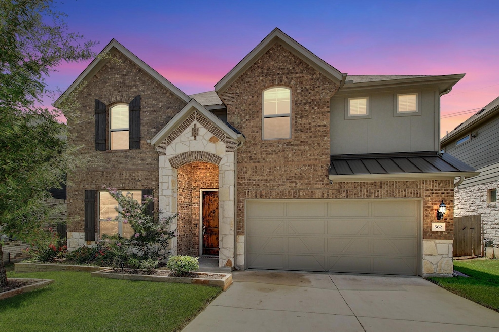 View of front of property featuring a garage, bri