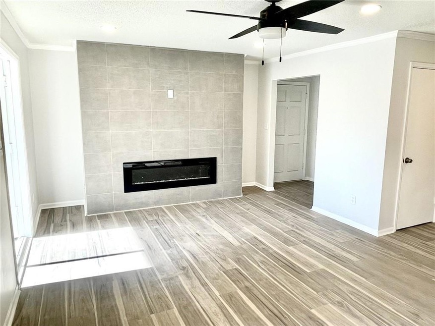 Unfurnished living room with crown molding, tile w