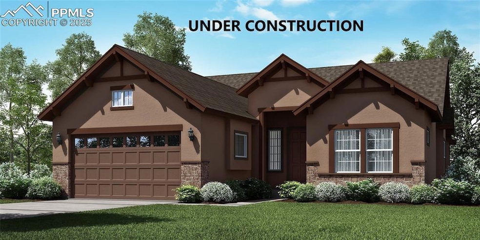 View of front of property with stone siding, a front yard, roof with shingles, and stucco siding