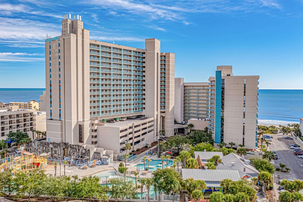 View of building exterior with view of water and beach