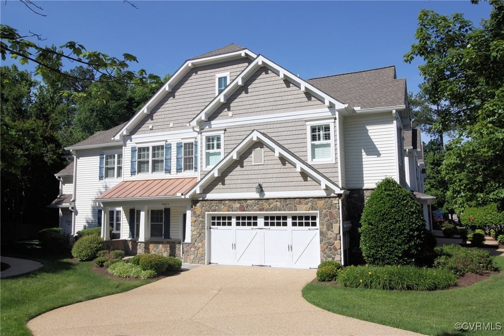 Craftsman house featuring driveway, stone siding,