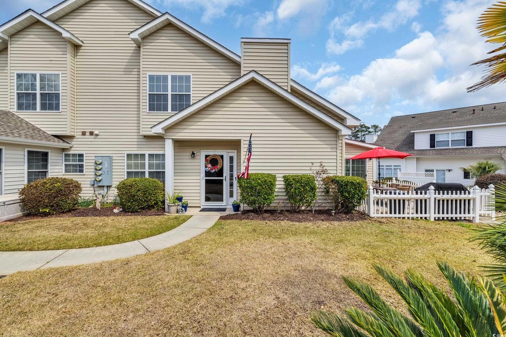 View of front of home with a chimney, a front yard
