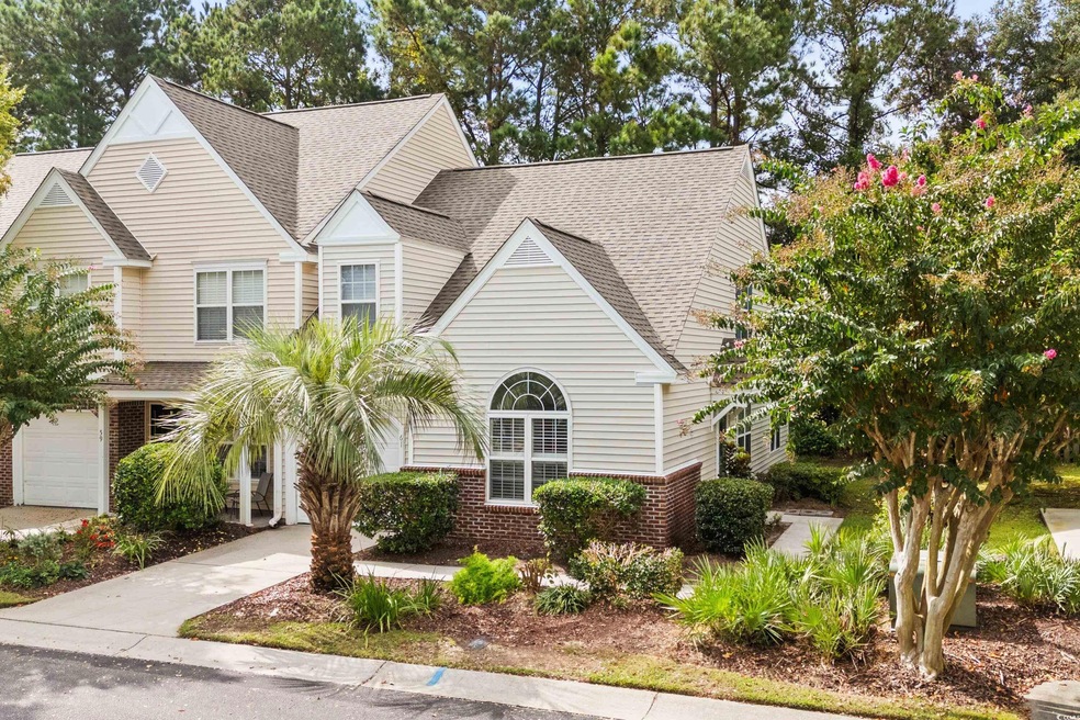 View of front facade featuring a garage