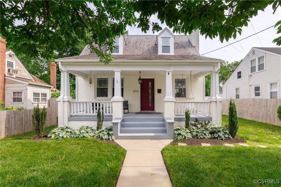 Cape cod house featuring covered porch, a chimney,
