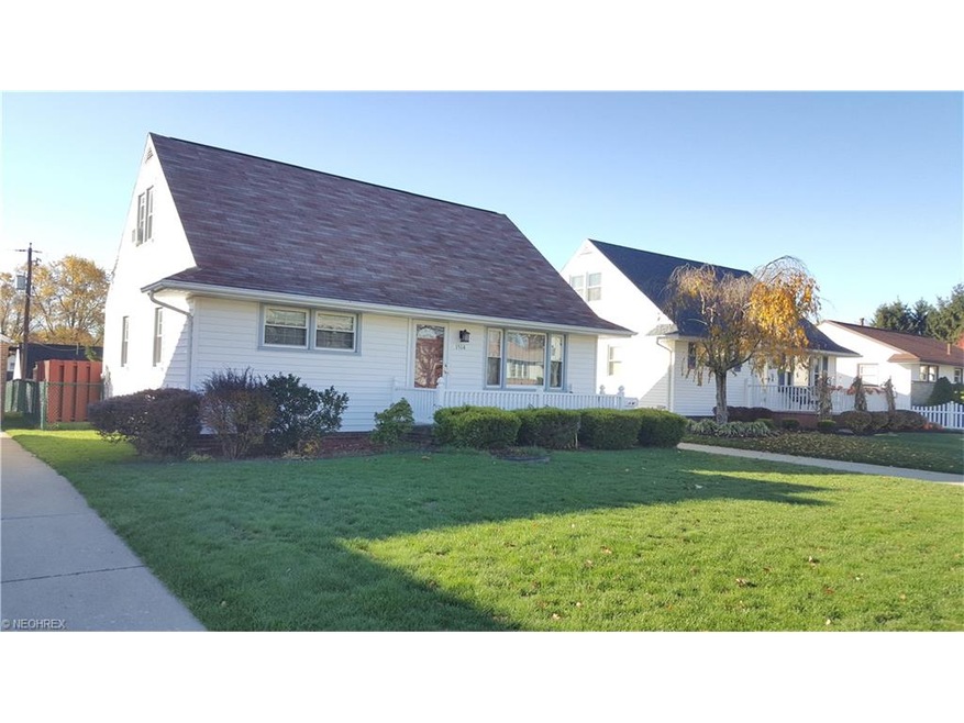 Front view of the home with nicely manicured bushe