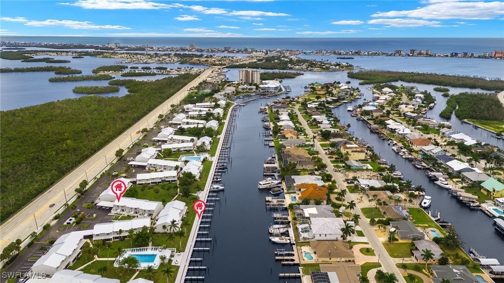 Birds eye view of property with a water view