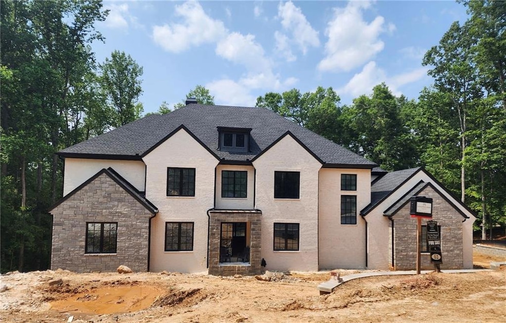 French provincial home featuring stone siding