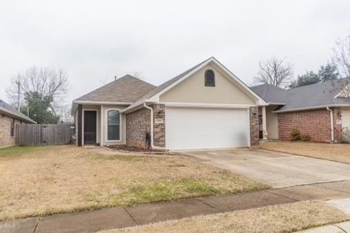 Ranch-style house with a garage and a front yard