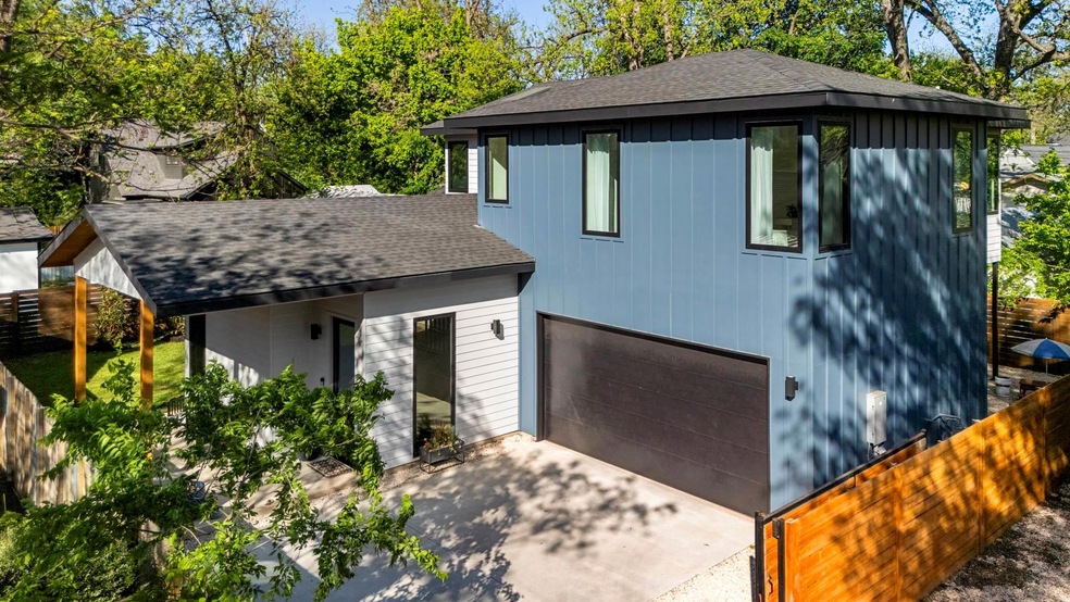 View of front facade with concrete driveway, a ga