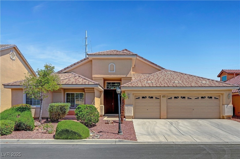 View of front of house featuring a tile roof, driv