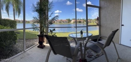Sunroom / solarium with a water view and a wealth of natural light