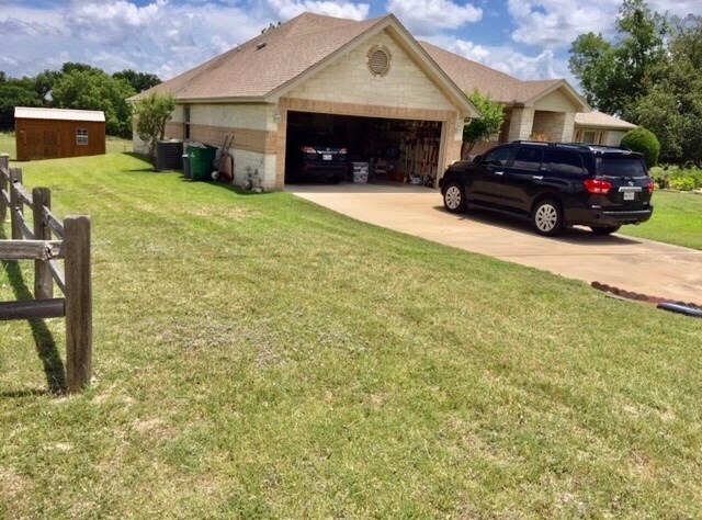 Front and side view.  See quality built storage shed.  Front loading 2-car garage.