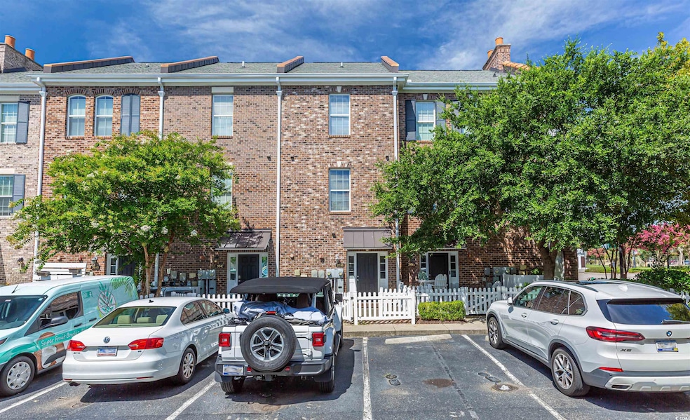 View of property with uncovered parking and fence 