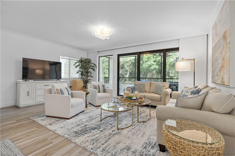 Living area featuring crown molding, wood finished