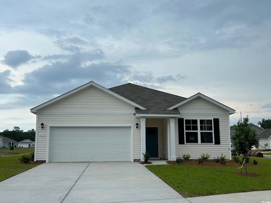 Ranch-style house with concrete driveway, a garage, and a front yard