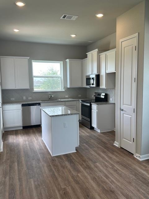Kitchen with stove, dishwasher, dark wood-style f