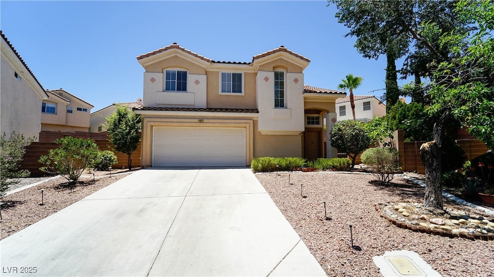 View of front of home featuring a tiled roof, conc