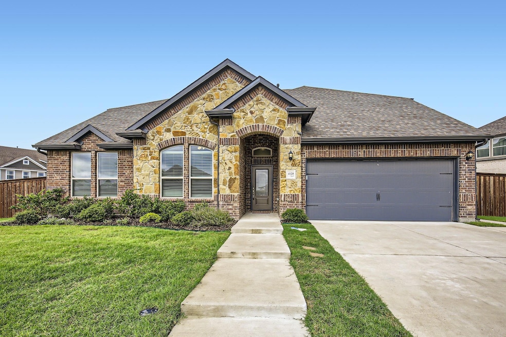 View of front of home featuring a garage and a fro