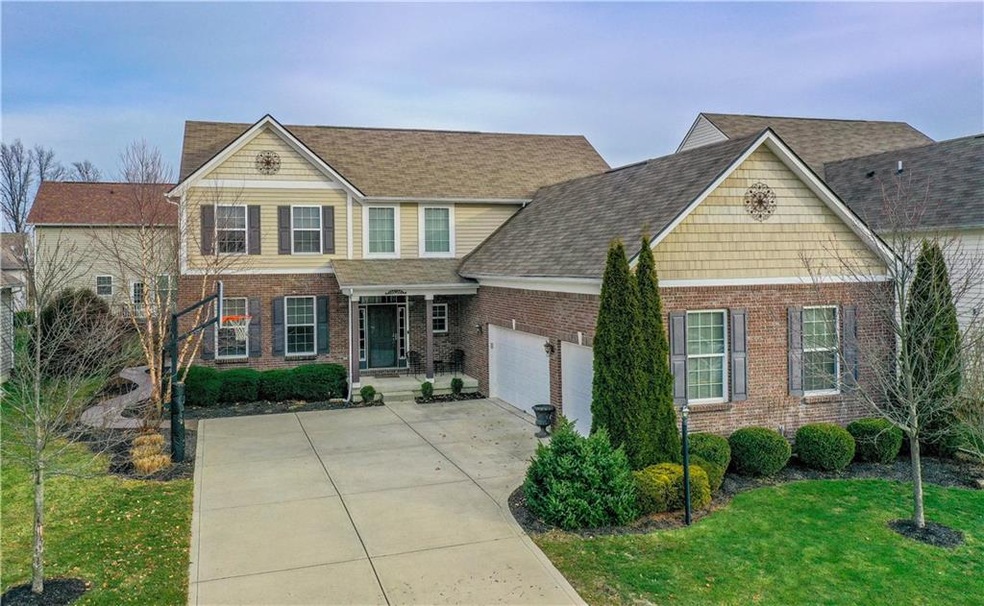 Beautifully landscaped court yard garage entrance with basketball goal for some outdoor fun!  