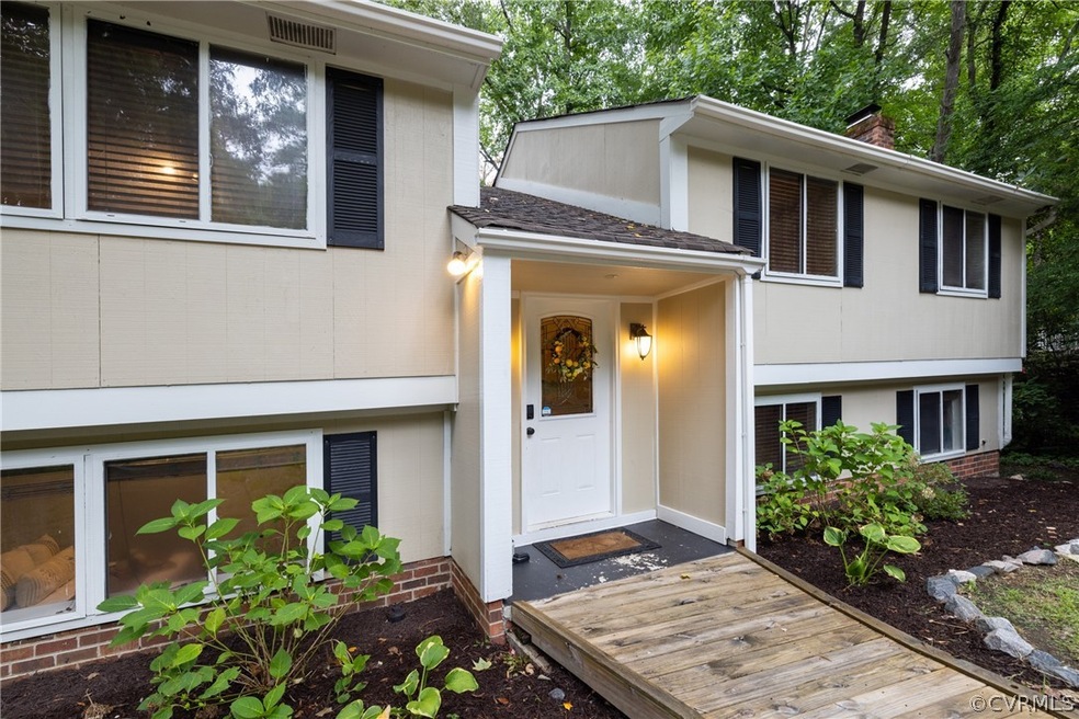 View of front of property with a wooden deck